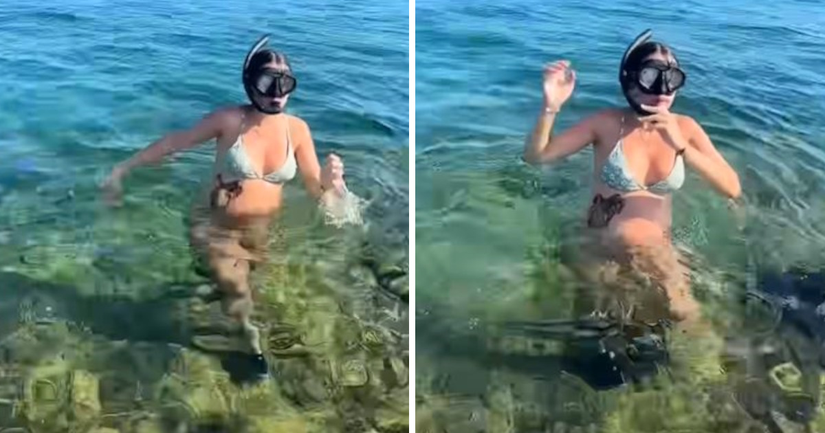 Pregnant lady emerges from water unaware creature is clinging to belly